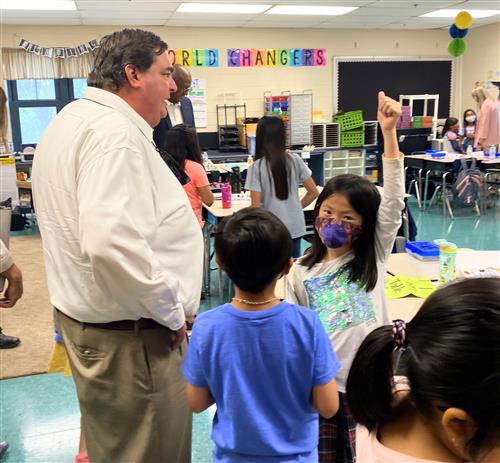 students talking with board member Greg Hulsey